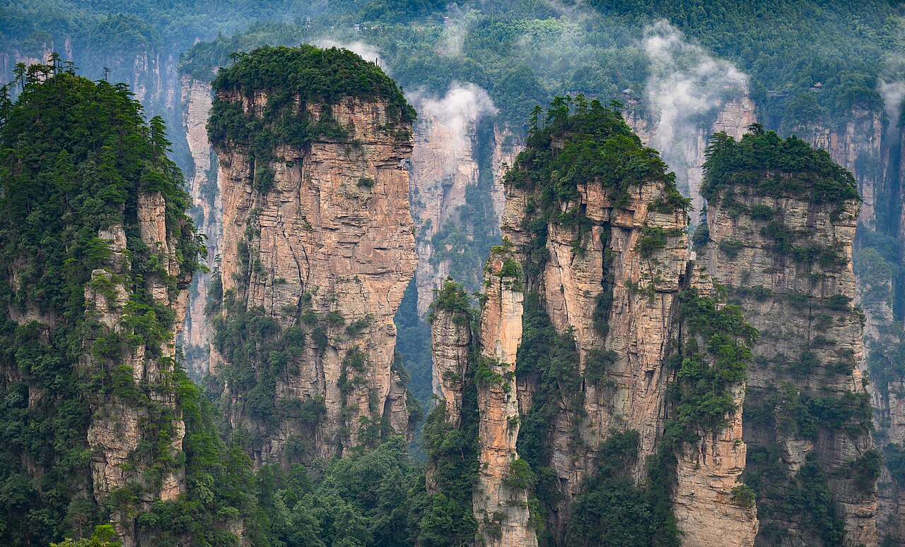 The sandstone pillars of Zhangjiajie rising through mist